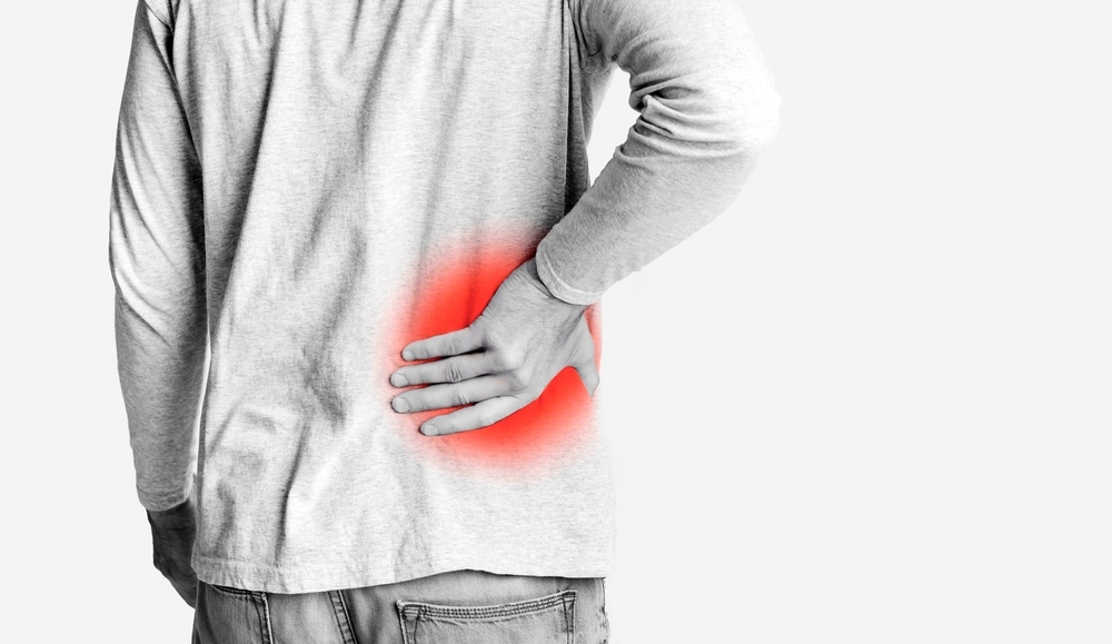 Young,Man,Holding,His,Pain,Back,,Monochrome,Photo,With,Red,