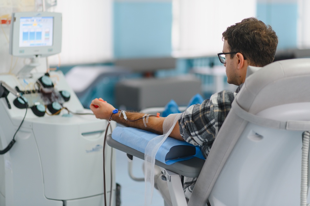 Man,Sitting,On,A,Medical,Chair,,Donating,Blood,For,Plasma