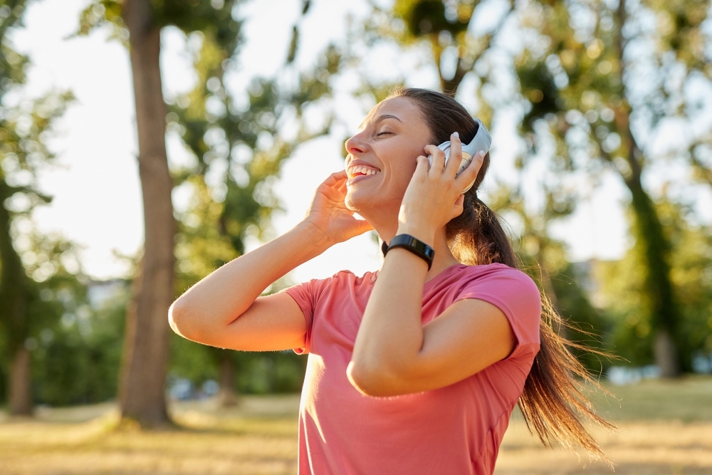 A,Woman,Jogs,In,A,Park,During,The,Evening,,Wearing